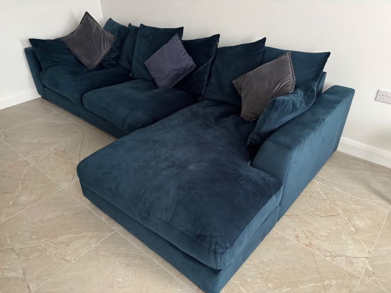Velvet pillow back navy sofa 
