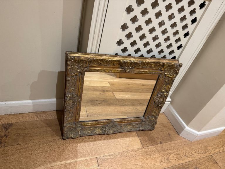 Ornate gold coloured wood framed mirror