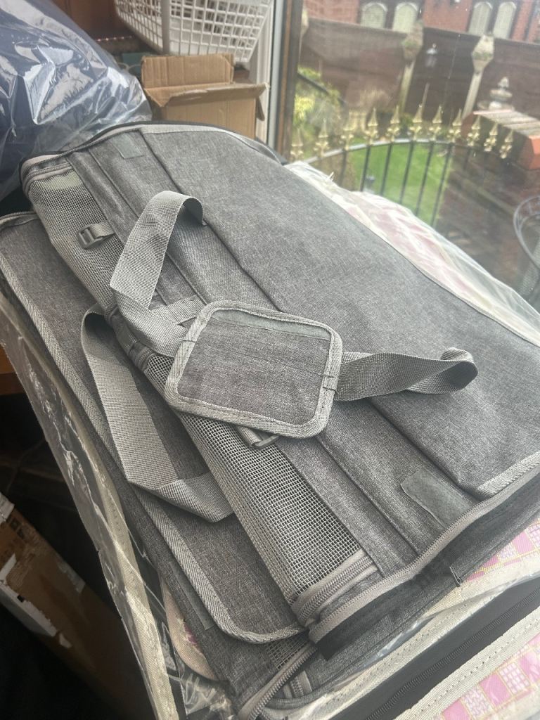 Foldable, soft-sided pet carrier.