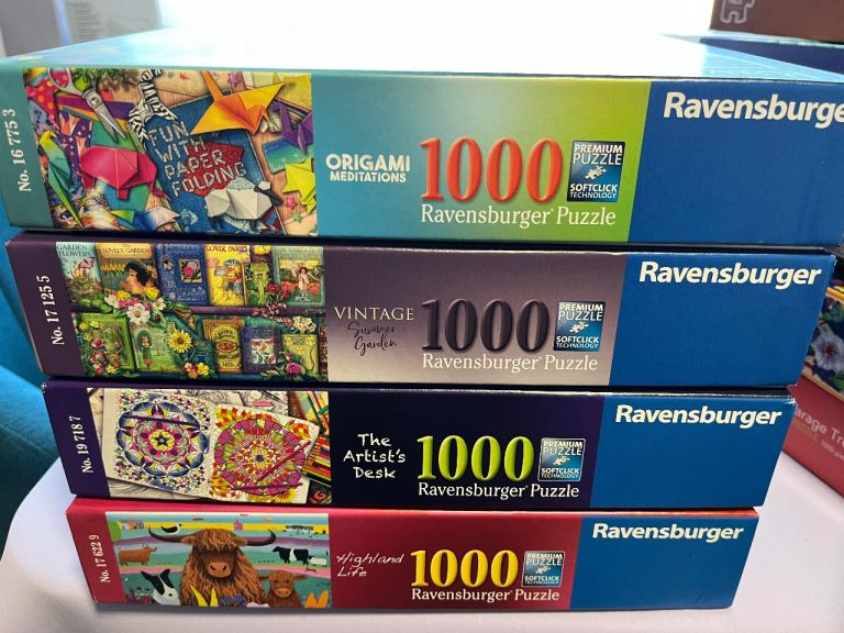 Four 1000 piece Ravensburger puzzles