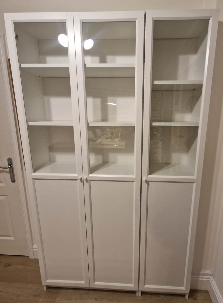 Billy bookcases' with panels and glass doors