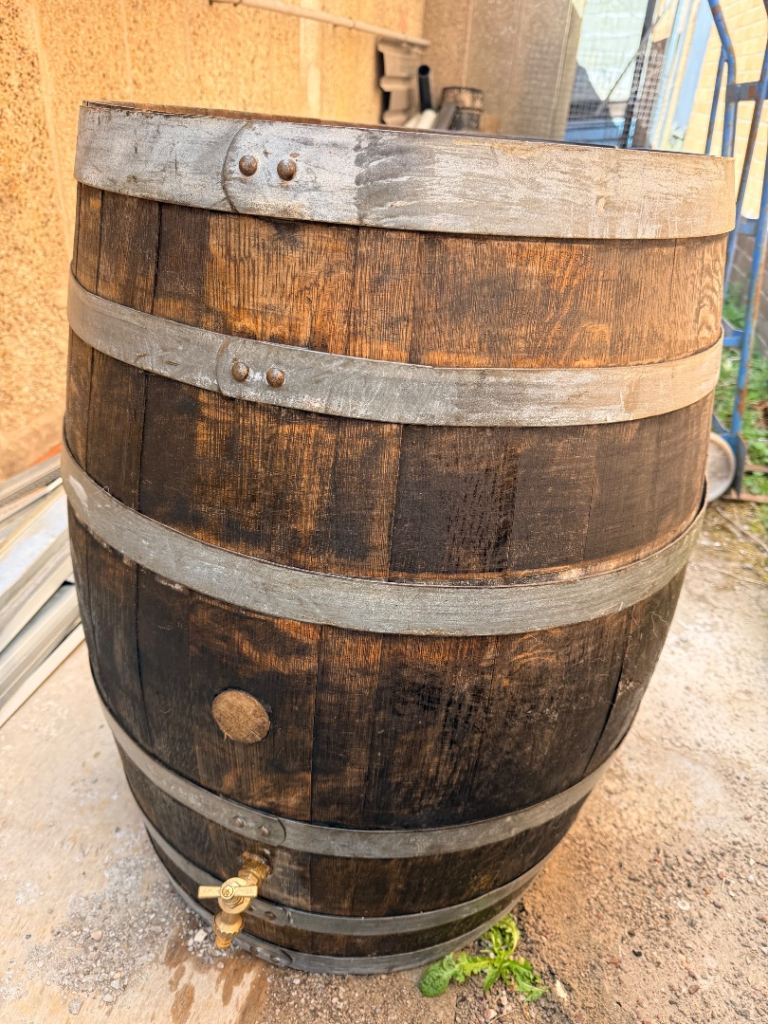 Whiskey barrel cleaned up and metal refurbished 
