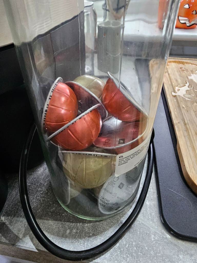 Nespresso veturo pod coffee maker machine in white with Nespresso cups/saucers, storage jar and pods