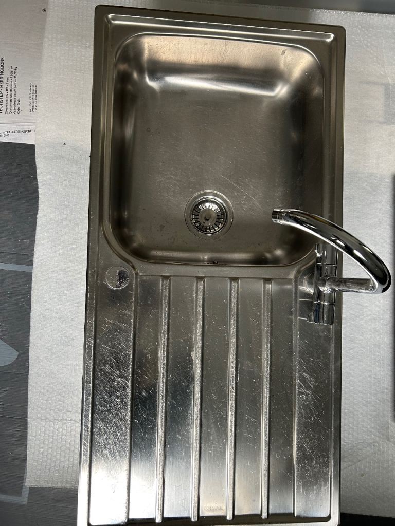 Stainless steel kitchen sink and mixer taps