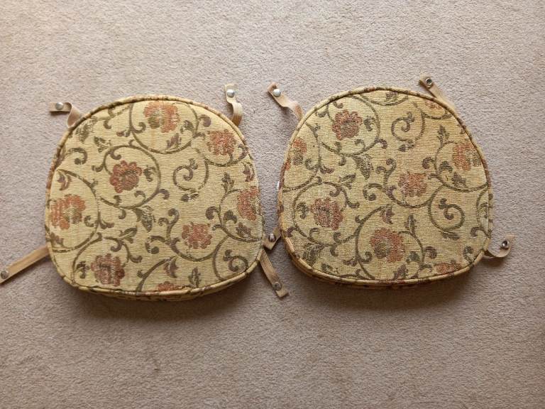 A pair of seat pads with covers suitable for Ercol Windsor dining chairs