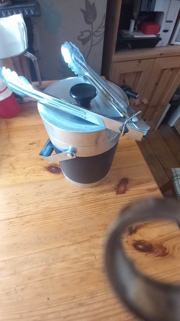 Stainless steel and faux leather ice bucket with tongs