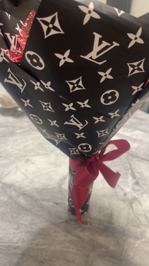 Red roses with diamonds on it wrapped in paper