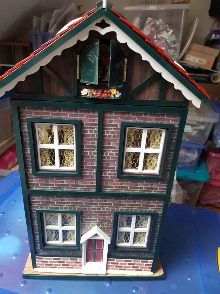 Christmas musical house, model village and a selection of feathered model birds