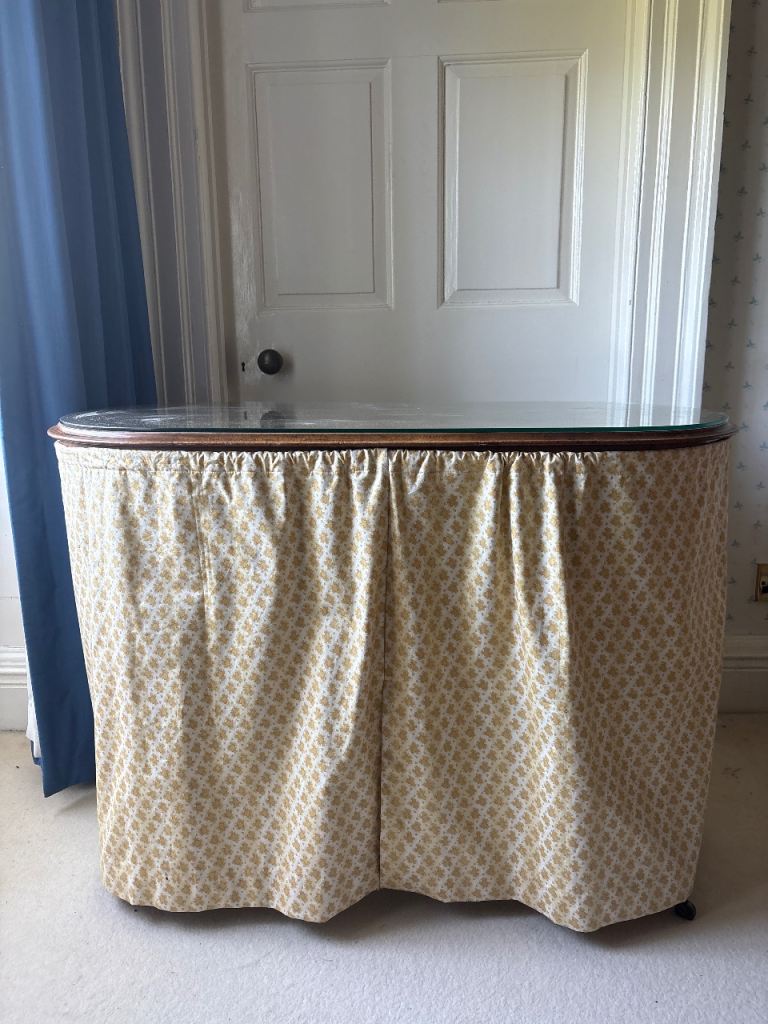 Vintage dressing table with yellow curtain and glass top 