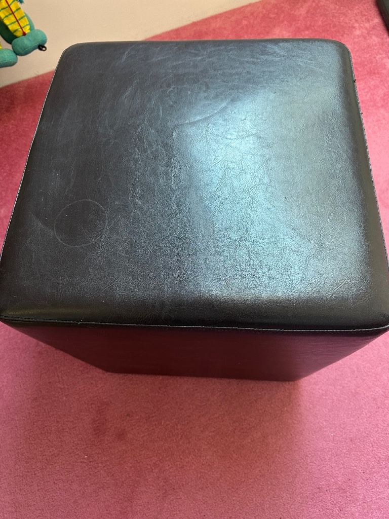 Black leather pouffe
