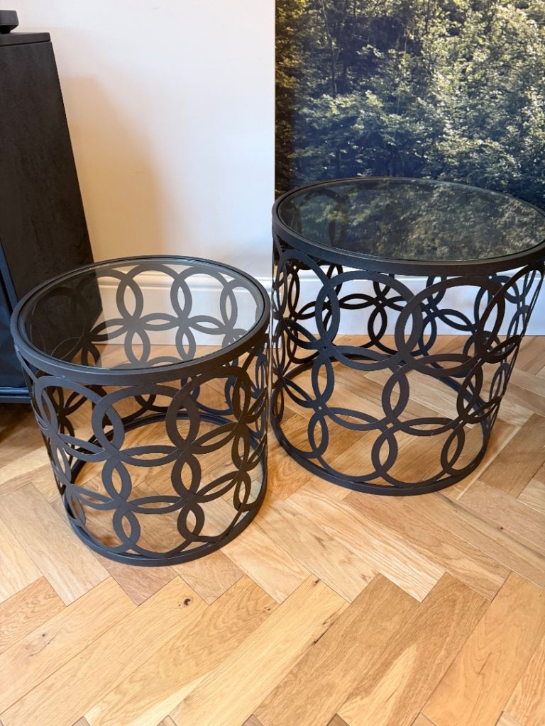 2x metal round nesting tables with glass tops 