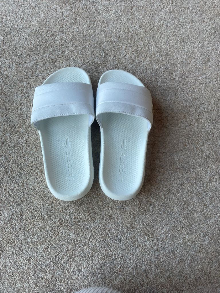 Women’s Lacoste white sliders 