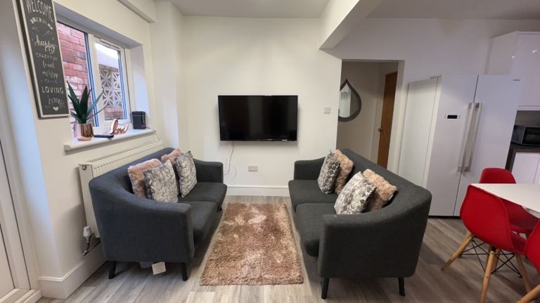 Two Grey Fabric Two-Seater Sofas – Good Condition