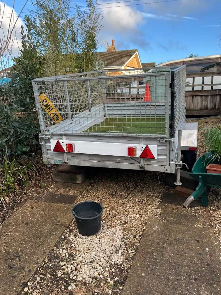 Seven by five full caged trailer,,is larger by few inches,,h duty sprung full axle ,13in wheels,