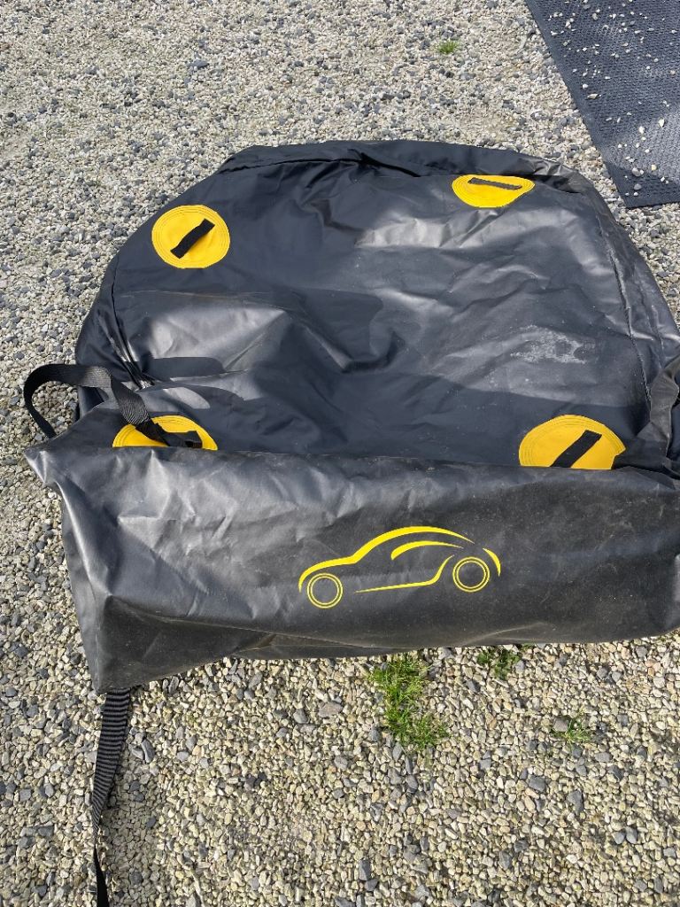 Large black car roof storage bag.
