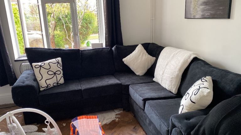 black corner sofa with silver feet 