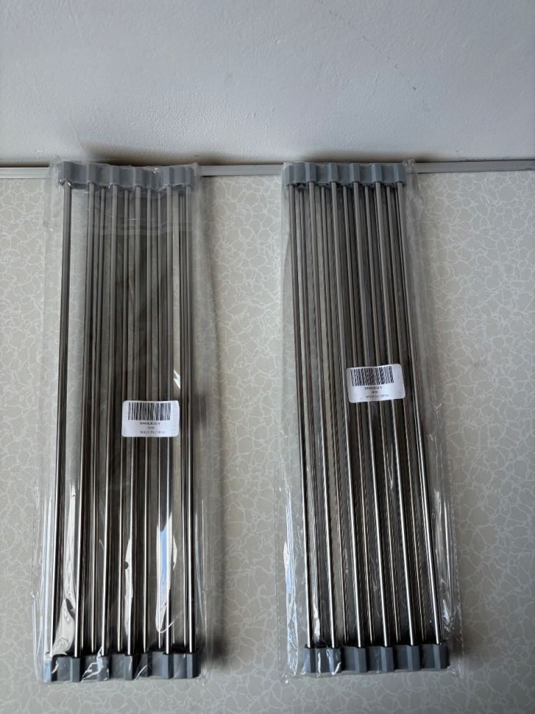 2x stainless steel roll-up dish drying rack with grey silicone ends.