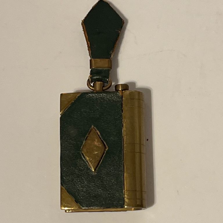 Antique Trench Art Brass Green Cover Book Pocket Petrol Lighter with Diamond Shaped Holding Tag.