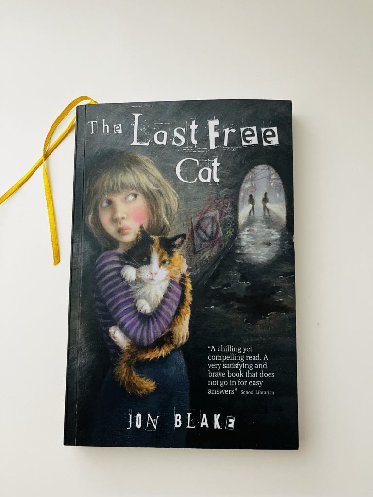 The Last Free Cat by Jon Blake. Never read, immaculate. Teen readers
