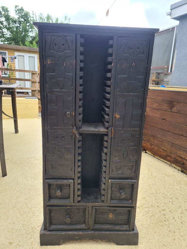 African-style or tribal-themed furniture...Hand-carved wooden CD storage unit,