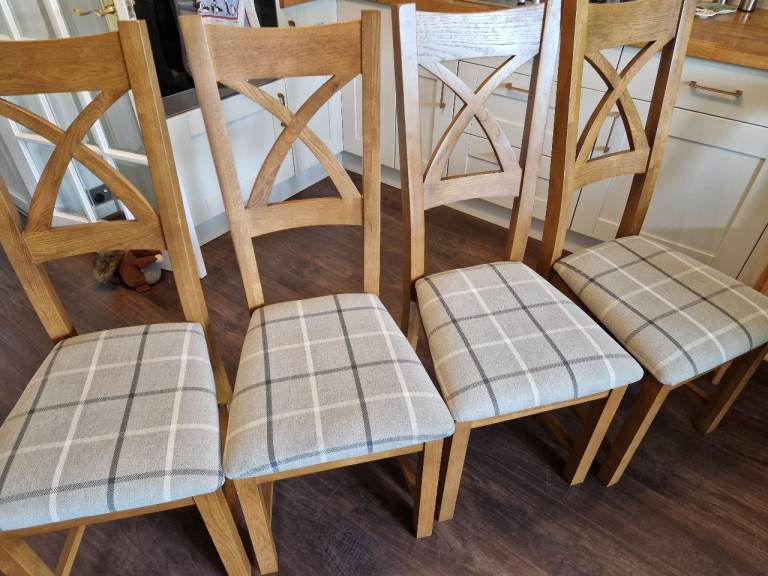 Dining chairs x 4, solid oak with fabric upholstery.