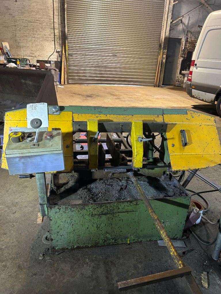 Rusch metal cutting band saw with roller bed and back stop