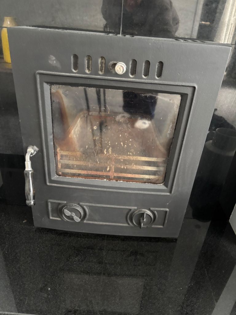 Multi fuel inset stove burner with black marble fireplace and hearth 