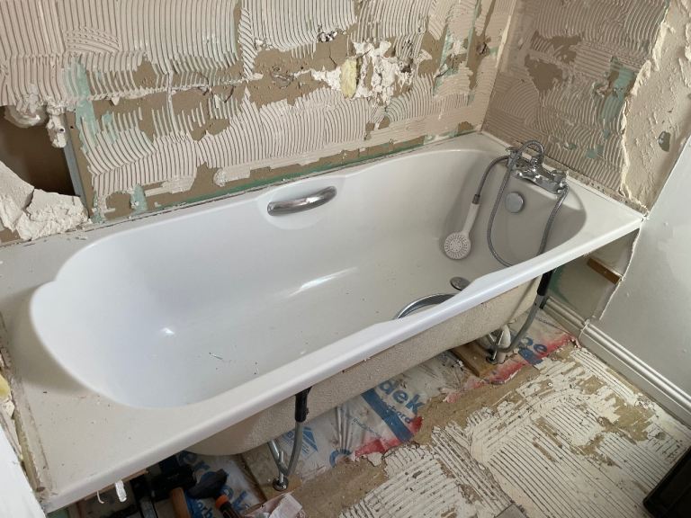 White Bathtub with Mixer Tap and Shower Head