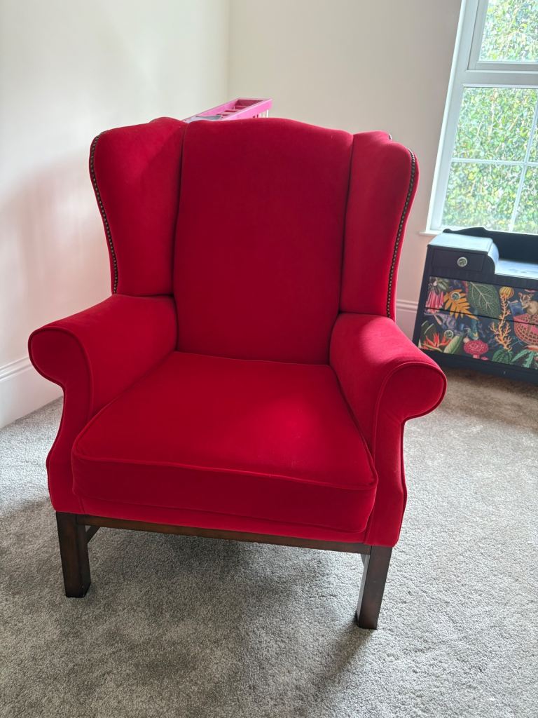 Red velvet wing chair