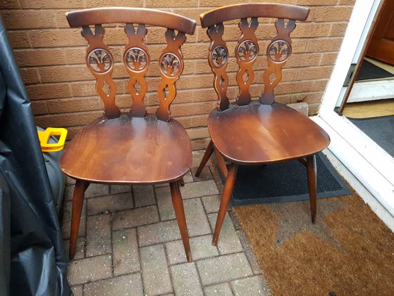 Pair of Ercol fleur de lys chairs