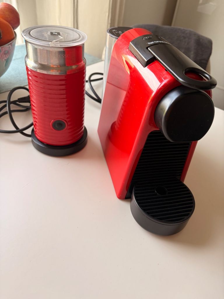 Nespresso De'Longhi Essenza Mini coffee machine with milk frother and capsules. 