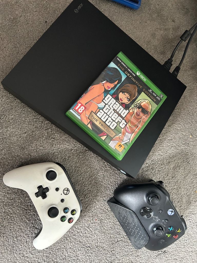 Xbox One X Console with Grand Theft Auto and Two Controllers