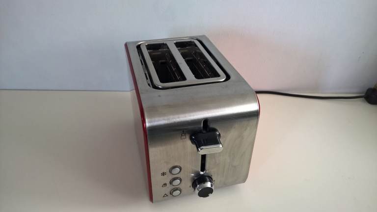 Two Slots Stainless Steel Toaster with Red sides in perfect clean working condition,