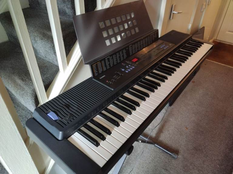 image for Electric keyboard Casio with power lead and stand in very good condition good working order 