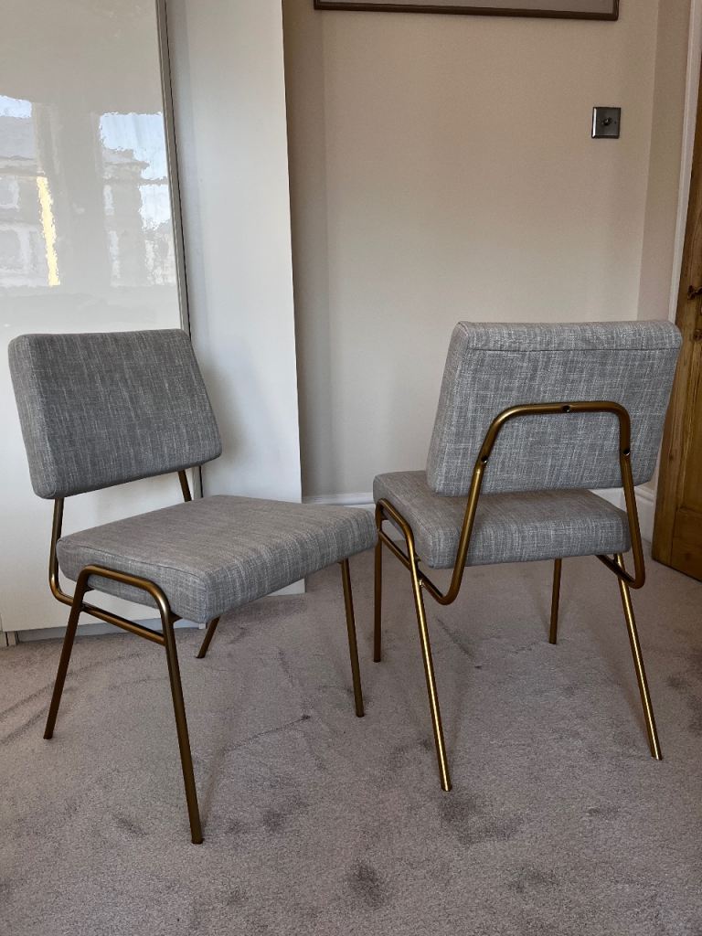 Pair West Elm grey upholstered padded dining chairs with gold legs