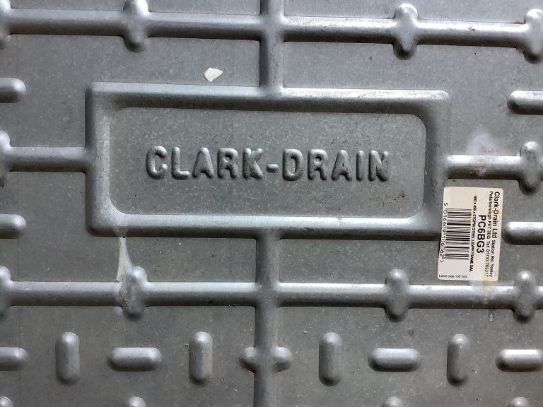 Drain inspection cover and frame for driveway.