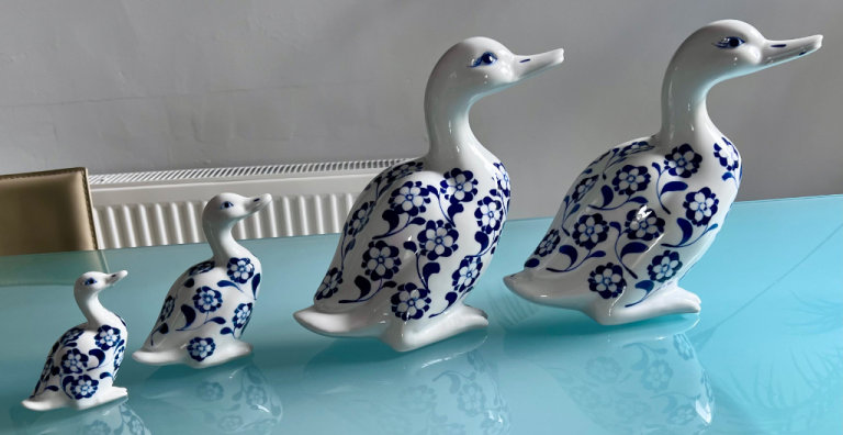 Large group of ceramic hand painted ducks geese