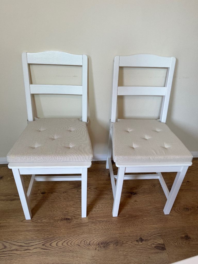 2 IKEA white dining chairs with cushions