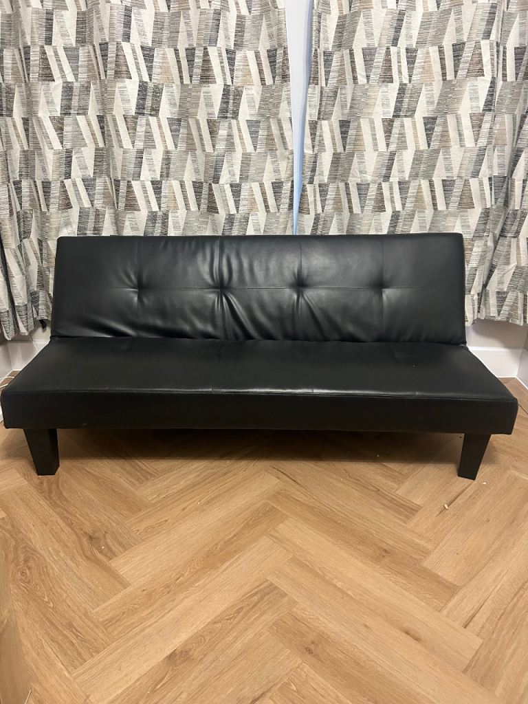 Black faux‑leather sofa bed/futon