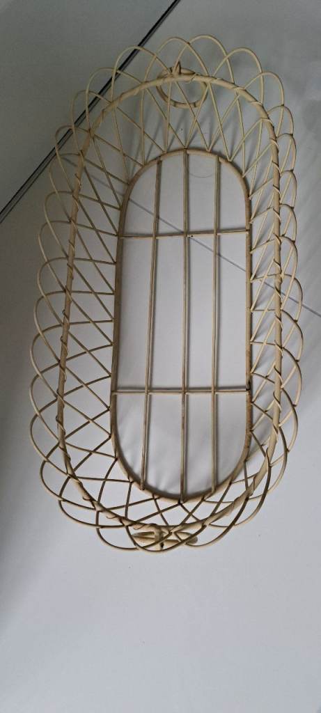 Large cream wire basket with ring handles.