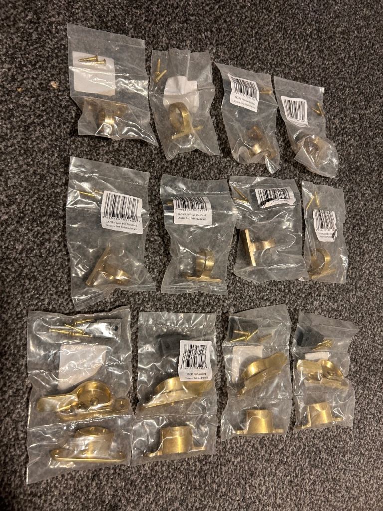 A job lot of polished brass Fitch locking fasteners and sash eyes, all brand new.