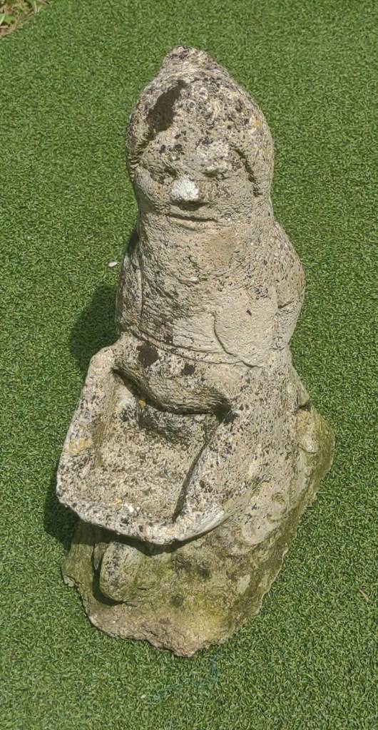 Beautifully weathered vintage reconstituted stone garden gnome pushing wheelbarrow
