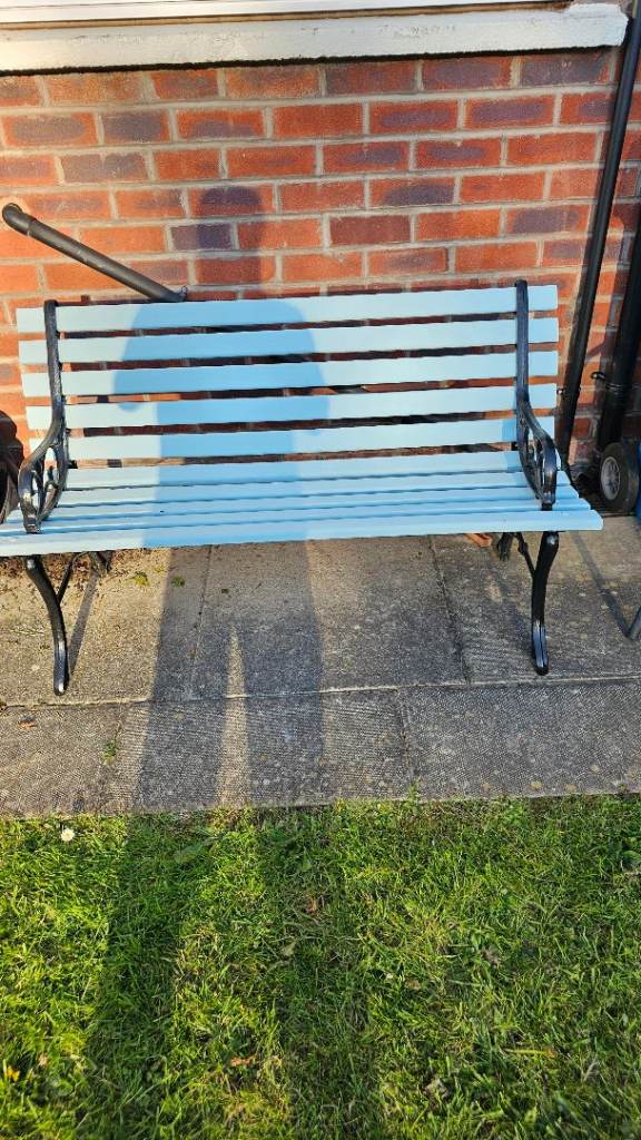 A lovely garden bench with cast legs 