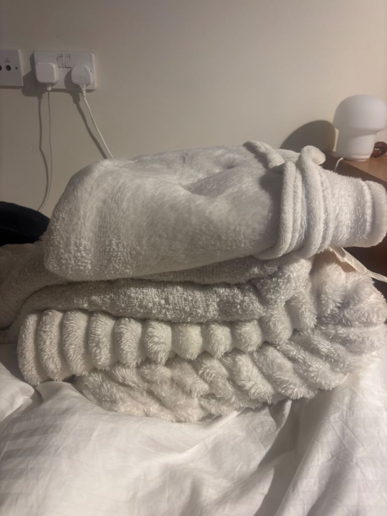 bundle of white throw blankets 
