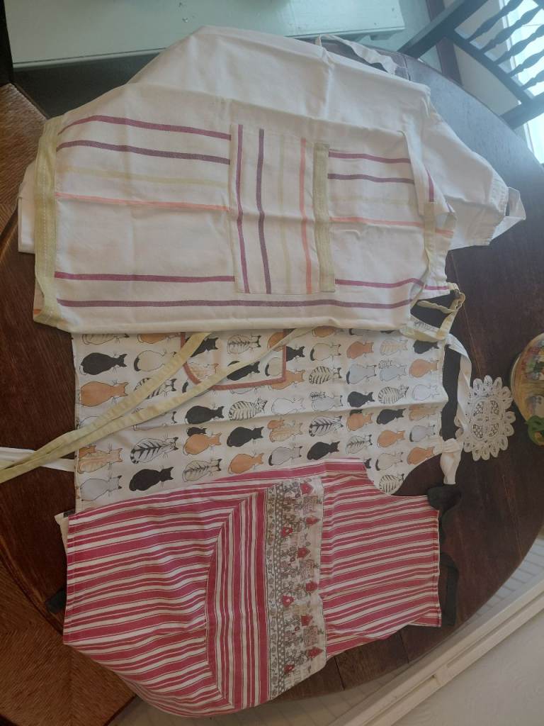 Set of 4 Fabric Aprons – Good Condition