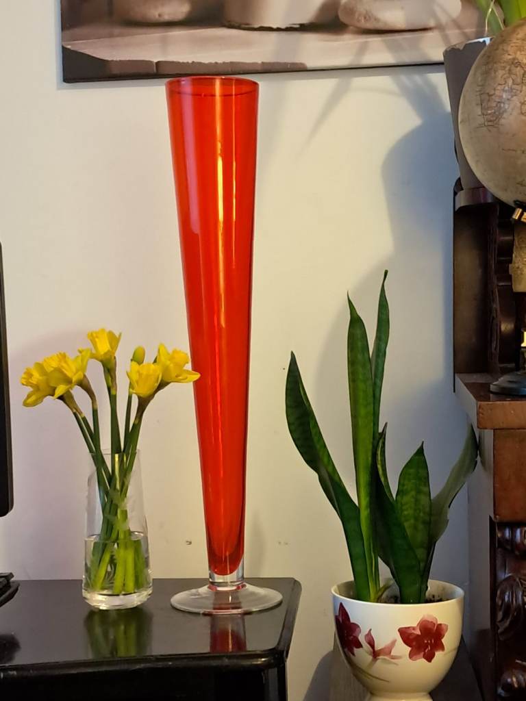 This is a Vintage tall,red glass trumpet vase with a clear base.Measurements is 23-inch height. 