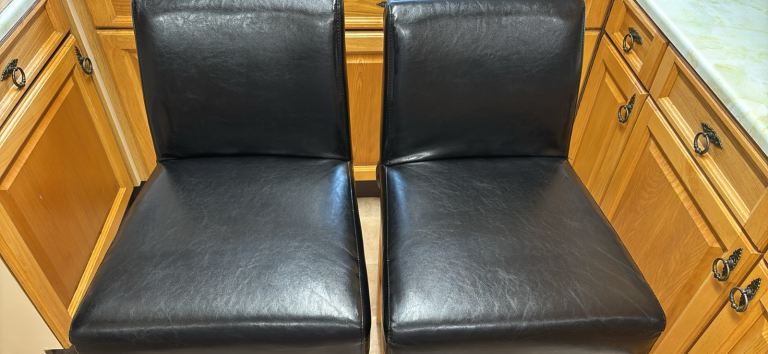 Pair of Black Faux Leather Bar Stools with Light Wood Legs