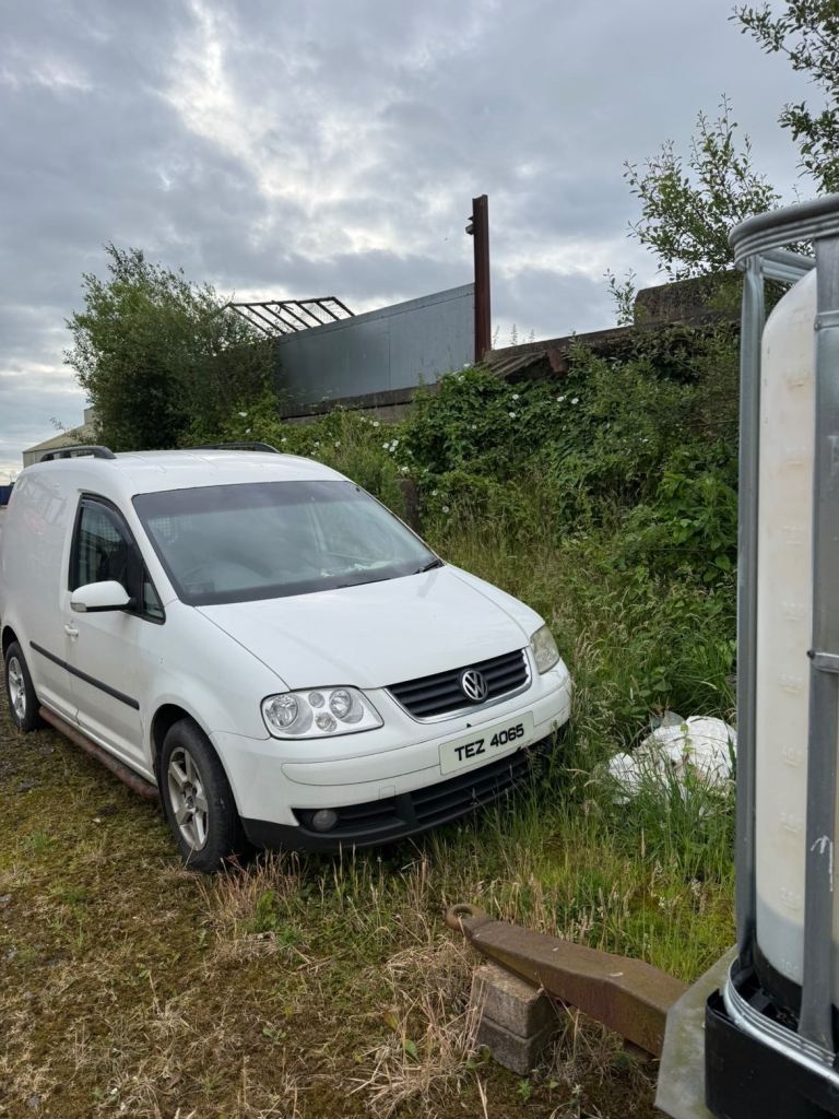 White 2007 caddy van 