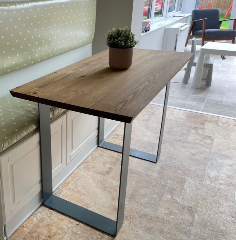 Real wood dining table with cast iron legs. 