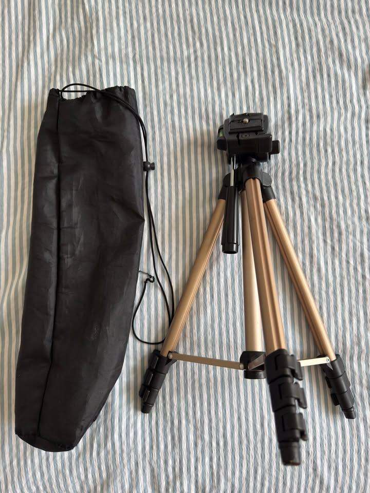 image for Lightweight adjustable tripod with sturdy legs, spirit level, and secure quick-release plate